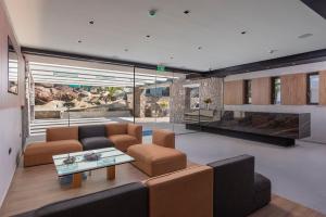 a living room with a couch and a table at LaLiBay Resort & Spa - Adults Only in Perdika