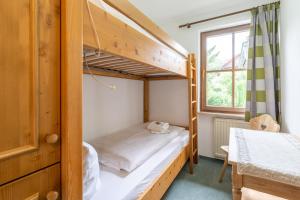 a bedroom with two bunk beds and a window at Magdalena in Bad Hindelang