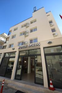 a hotel with a sign on the front of a building at SPİLOS GÜMÜLDÜR HOTEL in İzmir