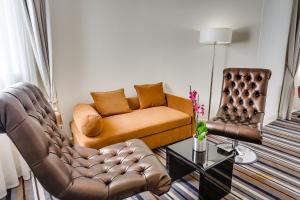 a living room with a couch and a chair at Mercure Rostov-On-Don Center in Rostov on Don