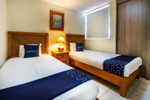 A bed or beds in a room at Suites Navata