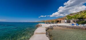 a house on the shore of the ocean at LaLiBay Resort & Spa - Adults Only in Perdika
