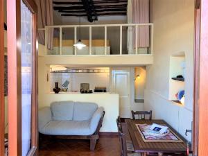 a living room with a couch and a table at Casa Papuzza in Malfa