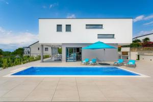 a villa with a swimming pool and a house at Villa LEA MAGDALENA in Malinska