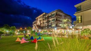 a group of kites sitting on the grass in front of a building at Phanomrungpuri Hotel Buriram in Nang Rong