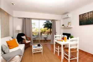 a living room with a couch and a table at Apartamento Can Poma in Alcudia