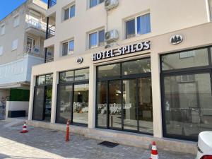 a store front of a building with large windows at SPİLOS GÜMÜLDÜR HOTEL in Izmir