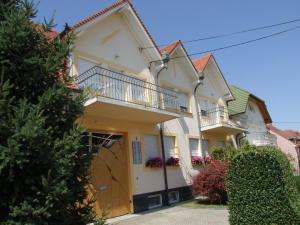 a large white house with a balcony at Apartment Révész in Harkány