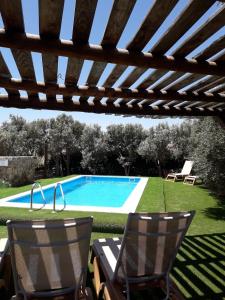 a patio with two chairs and a swimming pool at Agroturismo La Gayria in Tiscamanita