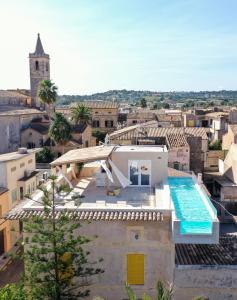 a villa with a swimming pool on top of a building at Hotel Boutique Can Pocovi in Sant Llorenç des Cardassar