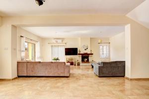 a large living room with couches and a fireplace at Villa Eva in Ayia Napa