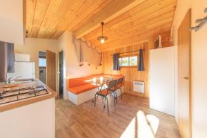 a kitchen and living room with a table and chairs at Camping du Lac de Saujon in Saujon +33 photos