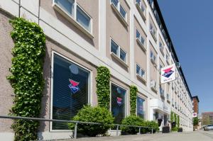 a building with windows with blue blinds on it at Cabinn Scandinavia in Copenhagen