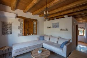 a living room with a couch and a table at To Spiti mas in Sougia