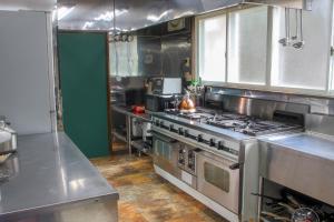 a kitchen with a stove top oven in a kitchen at Maple Chalet Hakuba in Hakuba