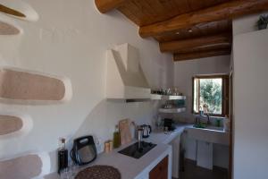 a kitchen with a sink and a counter top at To Spiti mas in Sougia