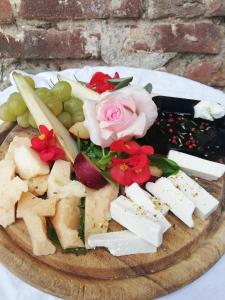 a plate of food on a table with a rose at Agriturismo Fiamberta in Certosa di Pavia