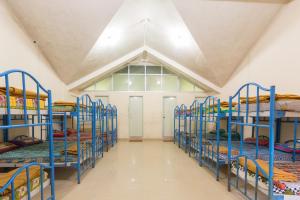 a group of bunk beds in a room at KSTDC Hotel Mayura TalaKaveri, Bhagamandala in Madikeri