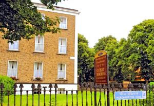 a sign in front of a large brick building at Morehampton Townhouse in Dublin