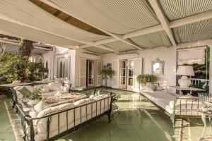 a large living room with couches and tables at Villa Prestige '50 in Capri