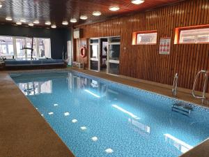 a large swimming pool in a building at Eastwatch guesthouse in Berwick-Upon-Tweed
