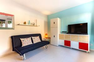 a living room with a couch and a flat screen tv at BeachApartment in Corralejo