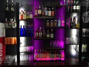 a bar with a bunch of bottles of alcohol at Hotel Complex Uhnovych in Ternopilʼ
