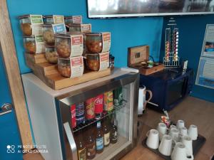 a store with a shelf with bottles of sauce at Hôtel des Rochers in Perros-Guirec