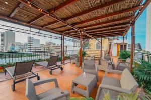 a balcony with chairs and a view of the city at Hotel Casa Tere in Cartagena de Indias