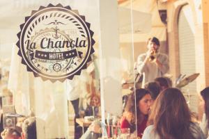 a man standing in front of a mirror at a restaurant at Hotel La Chancla in Málaga