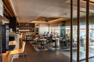 a restaurant with people sitting at tables in a room at Hotel La Chancla in Málaga