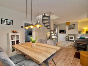 a dining room and living room with a wooden table at A Character Cottage in Historical Canterbury in Canterbury