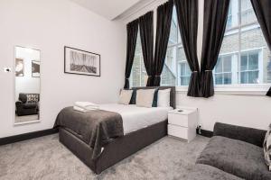 a bedroom with a bed and a couch and a window at Host & Stay - Exchange Quarters in Liverpool