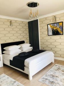 a bedroom with a large white bed with white pillows at The Classic Studio in Buzău