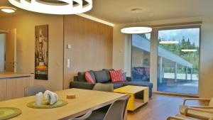 a living room with a couch and a table at Apartment Fastenberg Schladming - Top11 by AA Holiday Homes in Schladming