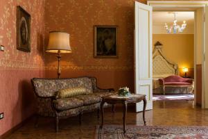 a living room with a couch and a table at Castello Di Spessa - Residenze d'epoca in Capriva del Friuli