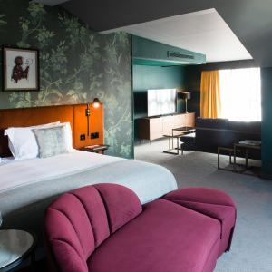 a hotel room with a large bed and a couch at Hotel Du Vin Stratford in Stratford-upon-Avon
