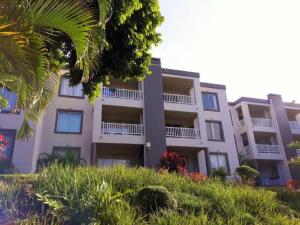 a white building with balconies on the side of it at Laguna La Crete Beach Apartment 206 in Margate