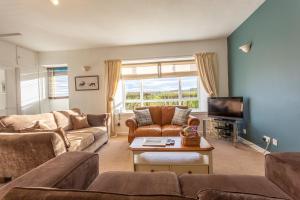 a living room with two couches and a tv at East Linton 4 Bedroom Cottage in East Linton