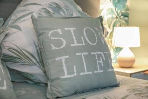 a pillow with the words stop them sitting on a bed at Elégance Art Déco en bord de Loire in Blois