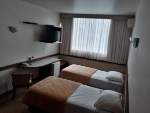 Ліжко або ліжка в номері Atalaia Palace Hotel