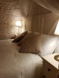 A bed or beds in a room at Trulli D'Angiò