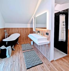 a bathroom with a sink and a bath tub at Marie Antoinette in Schwandorf in Bayern