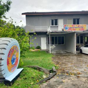 a house with a large tire in front of it at Inap Bayu TC in Kuantan