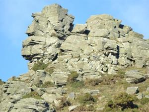 a rocky mountain with a blue sky in the background at The Sandrock Lynton in Lynton +3 photos