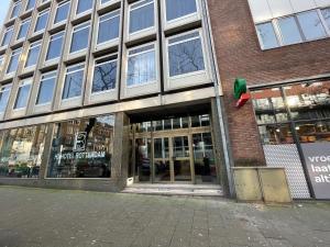 a store front of a brick building with windows at H3 Hotel Rotterdam City Center in Rotterdam