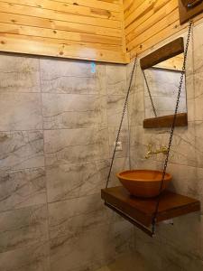 a bathroom with a wooden bowl on a swing at Ali's Bungalow in Kaş