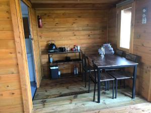 a dining room in a log cabin with a table and chairs at Old Mill House Log Cabins in Dorchester +37 photos