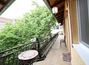 a balcony with a table and chairs on a balcony at Apartments & Rooms Vienna in Osijek