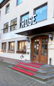 a building with a red carpet in front of a door at Hotel Goldene Rose in Ebersbach an der Fils